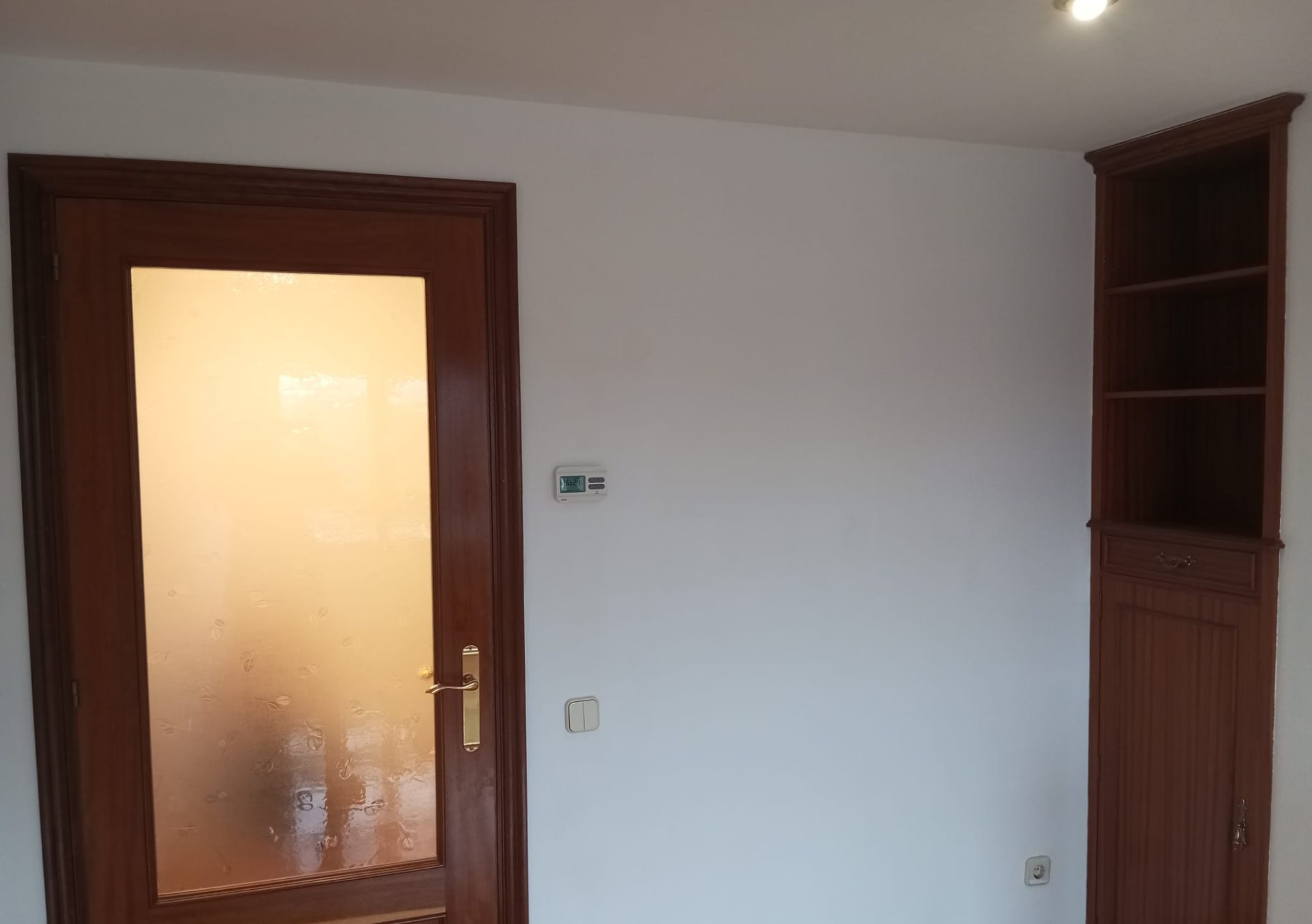 Salón con paredes pintadas en blanco y carpintería de madera